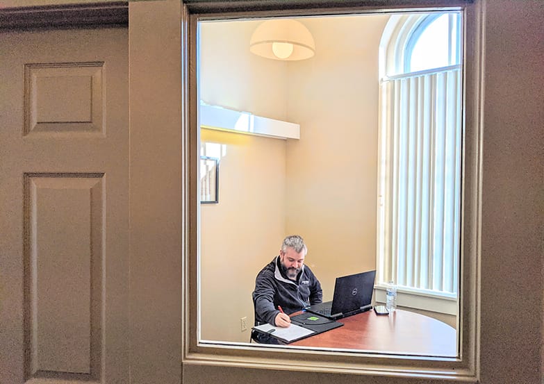 A FOCUS Coworking member doing work in an office